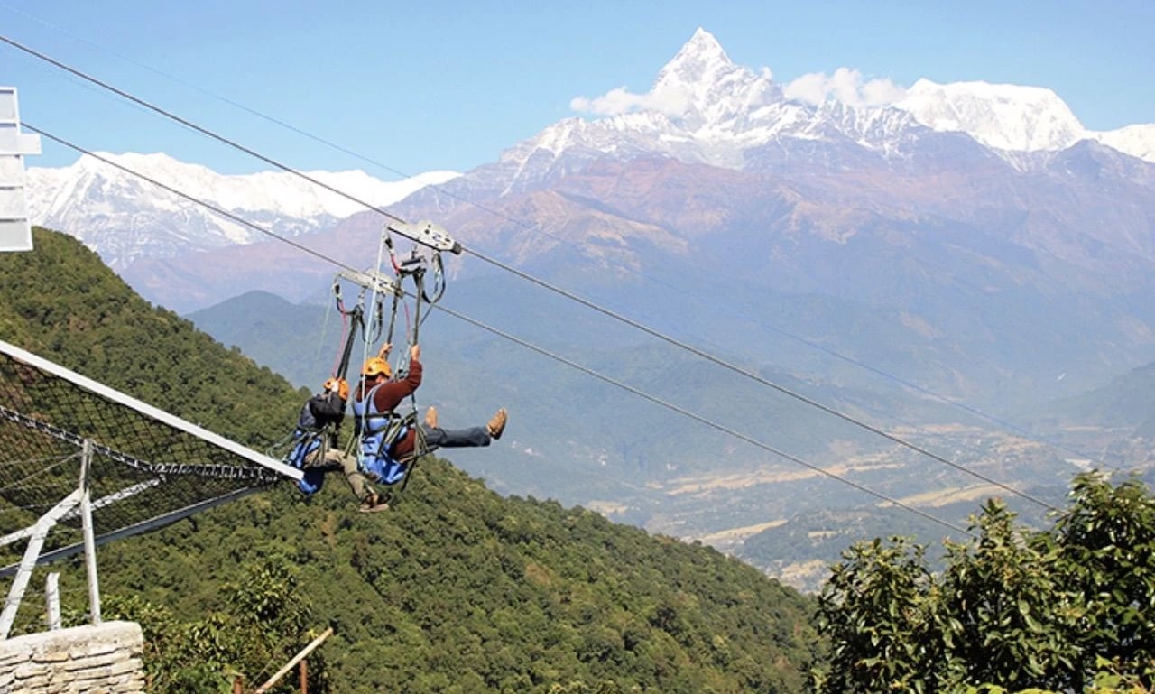 Two people exciting ziplines in Nepal